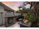 Outdoor kitchen with bar, grill, fire pit, and surrounding greenery, perfect for entertaining at 2207 Hickory Ave, Sarasota, FL 34234