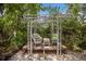 Backyard patio with seating, table, under a metal pergola at 2207 Hickory Ave, Sarasota, FL 34234