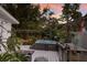 Outdoor area featuring a hot tub on a deck, tropical decor, and lush plants at 2207 Hickory Ave, Sarasota, FL 34234