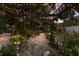 Lush backyard with a pergola covered with plants and decorative lighting at 2207 Hickory Ave, Sarasota, FL 34234