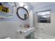 Modern bathroom with vessel sink, a round mirror, and a walk in shower at 2207 Hickory Ave, Sarasota, FL 34234