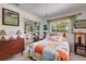 Bright and cheerful bedroom featuring colorful decor, mirrored closet doors, and a cozy atmosphere at 2207 Hickory Ave, Sarasota, FL 34234
