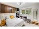 Cozy bedroom with built-in bookshelves, large window, desk and stool, offering a comfortable retreat at 2207 Hickory Ave, Sarasota, FL 34234