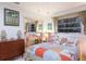 Bedroom with palm tree artwork, mirrored closet, and coastal bedding at 2207 Hickory Ave, Sarasota, FL 34234