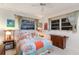Bright bedroom with coastal-themed bedding, two windows, and decorative touches at 2207 Hickory Ave, Sarasota, FL 34234