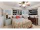 Cozy bedroom featuring two windows, ceiling fan, and floral bedding at 2207 Hickory Ave, Sarasota, FL 34234