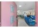 Interior view from the pink and teal front door to the kitchen and living room at 2207 Hickory Ave, Sarasota, FL 34234
