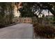 Charming home featuring mature trees, lush landscaping, and a welcoming driveway at 2207 Hickory Ave, Sarasota, FL 34234