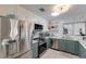 Well-lit kitchen featuring stainless steel appliances, modern fixtures, and ample counter space for cooking at 2207 Hickory Ave, Sarasota, FL 34234