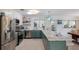 Charming kitchen with updated stainless steel appliances, marble countertops, and two-tone cabinetry at 2207 Hickory Ave, Sarasota, FL 34234