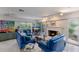 Bright living room features a white brick fireplace, ample seating, and large windows at 2207 Hickory Ave, Sarasota, FL 34234