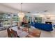 Bright living room featuring large windows, colorful artwork, and a unique light fixture for a modern, airy feel at 2207 Hickory Ave, Sarasota, FL 34234
