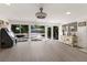 Bright living room with walls of windows, light wood floors, and neutral decor at 2207 Hickory Ave, Sarasota, FL 34234