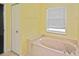 Bathroom featuring a large bathtub and window at 2371 Manheim Ave, North Port, FL 34286