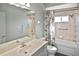 Bathroom with shower-tub combination, vanity and sink, grab bars and floral shower curtain at 2371 Manheim Ave, North Port, FL 34286