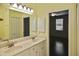 Bathroom featuring double sinks and doorway leading to bedroom at 2371 Manheim Ave, North Port, FL 34286