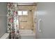 Shower-tub combination with tile surround, grab bars and floral shower curtain at 2371 Manheim Ave, North Port, FL 34286
