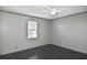 Bedroom with light gray walls, ceiling fan, and bright window at 2371 Manheim Ave, North Port, FL 34286