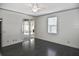 Bright bedroom with hardwood floors, ceiling fan, and sliding glass door to porch at 2371 Manheim Ave, North Port, FL 34286