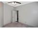 Neutral bedroom features a ceiling fan and a door that leads to another room at 2371 Manheim Ave, North Port, FL 34286