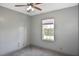 Neutral bedroom features a window with blinds and a ceiling fan at 2371 Manheim Ave, North Port, FL 34286