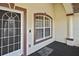 Welcoming front porch featuring a glass door, large window with fresh paint, and a nice view at 2371 Manheim Ave, North Port, FL 34286