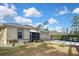 Charming single-story home with a well-manicured lawn, beautiful plants, and a screened-in front porch at 2371 Manheim Ave, North Port, FL 34286