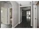 Inviting hallway with sleek flooring leading to a living area and bedroom with light and neutral paint at 2371 Manheim Ave, North Port, FL 34286