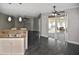 Open kitchen features white cabinets and stainless steel appliances, complete with breakfast bar at 2371 Manheim Ave, North Port, FL 34286