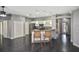Open kitchen features white cabinets, stainless steel appliances, breakfast bar, and wood flooring at 2371 Manheim Ave, North Port, FL 34286
