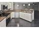 Open kitchen features white cabinets and stainless steel appliances, complete with breakfast bar at 2371 Manheim Ave, North Port, FL 34286