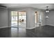 Spacious living room that features hard floors, access to the screened patio, and neutral colors at 2371 Manheim Ave, North Port, FL 34286