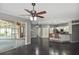 Open-concept living and kitchen area with dark floors and seamless transition to the outdoors through glass sliders at 2371 Manheim Ave, North Port, FL 34286
