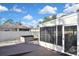 Back patio area features a screened-in lanai, fenced yard, and hot tub for outdoor enjoyment and relaxation at 2371 Manheim Ave, North Port, FL 34286