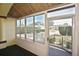 Enclosed front porch with large glass windows allowing ample natural light and an inviting outdoor experience at 2371 Manheim Ave, North Port, FL 34286