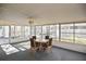 Enclosed sunroom with abundant windows and a ceiling fan offering a versatile space for relaxation or entertainment at 2371 Manheim Ave, North Port, FL 34286