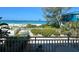 View from the balcony overlooking the backyard and beach at 2412 N Gulf Dr # 119, Bradenton Beach, FL 34217