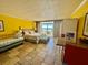 Bright main bedroom with tile flooring, daybed, and access to the balcony with great views at 2412 N Gulf Dr # 119, Bradenton Beach, FL 34217