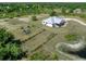 An aerial view showcases this property's expansive acreage and modern farmhouse design at 27510 67Th E Ave, Myakka City, FL 34251