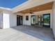 View of the back porch with concrete flooring, wood plank ceiling, and access to the home's interior at 27510 67Th E Ave, Myakka City, FL 34251