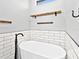 Modern bathroom features a white soaking tub with black matte faucet and subway tile backsplash at 27510 67Th E Ave, Myakka City, FL 34251