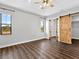 Primary bedroom with tray ceilings, fan and a barn door at 27510 67Th E Ave, Myakka City, FL 34251