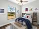 Bright bedroom with cheerful décor, natural light, and playful wall art at 27510 67Th E Ave, Myakka City, FL 34251