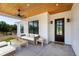 Inviting covered patio with ceiling fan, stylish seating, and rustic wood ceiling at 27510 67Th E Ave, Myakka City, FL 34251
