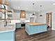 Well-designed kitchen with a butcher block island, modern appliances, white cabinets, and a custom range hood at 27510 67Th E Ave, Myakka City, FL 34251