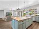 Open-concept kitchen and living area featuring a large butcher block island, and sleek cabinetry at 27510 67Th E Ave, Myakka City, FL 34251