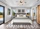 Serene main bedroom with tray ceiling, stylish décor, and views of the outdoors at 27510 67Th E Ave, Myakka City, FL 34251