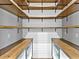 Walk-in pantry with custom wood shelving and white shiplap walls at 27510 67Th E Ave, Myakka City, FL 34251
