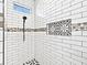 A walk-in shower features subway tile, accent tile, and a shower niche at 27510 67Th E Ave, Myakka City, FL 34251