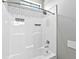 Clean white shower features tile surround, built-in shelves and overhead shower at 27510 67Th E Ave, Myakka City, FL 34251
